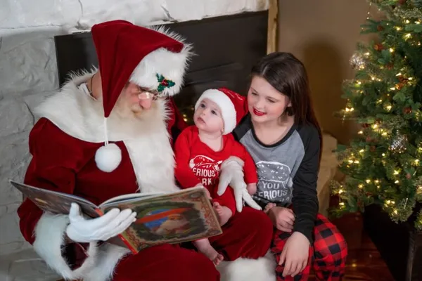 Santa Scott with children reading a book